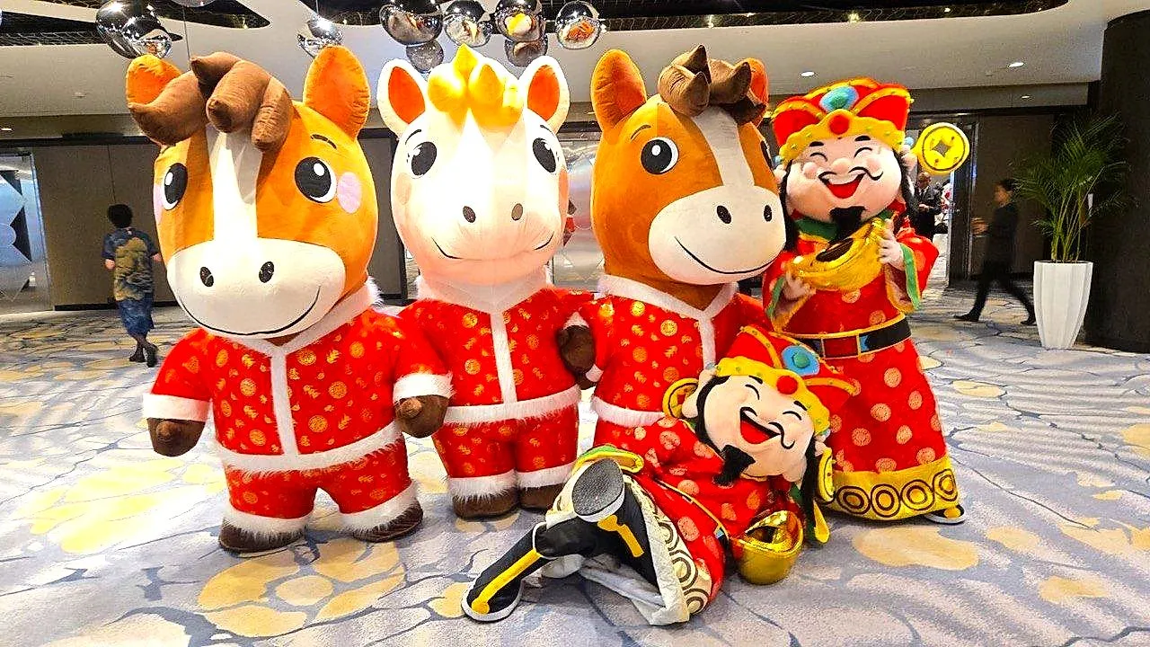 Festive mascots in red outfits posing in a hotel lobby